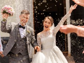 Happy wedding photography of bride and groom at wedding ceremony. Wedding tradition sprinkled with rice and grain