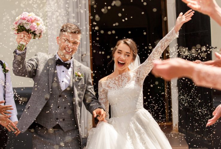 Happy wedding photography of bride and groom at wedding ceremony. Wedding tradition sprinkled with rice and grain